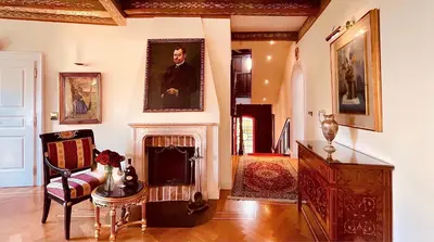a living room with a fireplace and a painting on the wall at Alchymist Prague Castle Suites Hotel in Prague