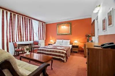 a hotel room with a bed and a desk at White House in Prague