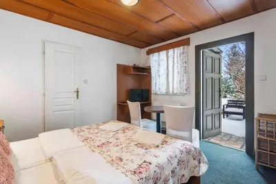 a bedroom with a bed and a table and a door at White House in Prague