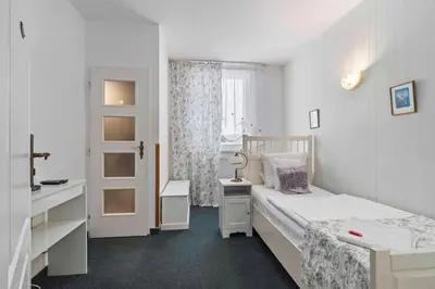 a small bedroom with a bed and a window at White House in Prague