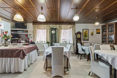 a dining room with white tables and chairs at White House in Prague