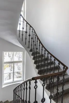 a staircase in a house with a window at Nice big apartment 2bds - Belgicka in Prague