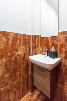 a bathroom with a sink and a mirror at Nice big apartment 2bds - Belgicka in Prague