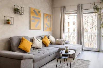 a living room with a gray couch with yellow pillows at Nice big apartment 2bds - Belgicka in Prague