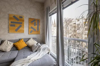a room with a bed and a large window at Nice big apartment 2bds - Belgicka in Prague