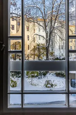 a window with a view of a snow covered yard at Nice big apartment 2bds - Belgicka in Prague