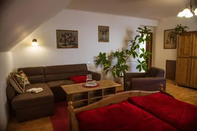 a bedroom with two beds and a couch and a window at Prague Sweet Home in Prague