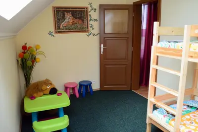 a hotel room with two beds and a chair at Prague Sweet Home in Prague