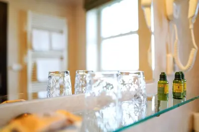a group of glasses and bottles on a counter at Rezidence Liběchov in Liběchov