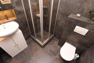 a bathroom with a shower and a toilet and a sink at Apartments near the pond in Prague