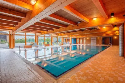a large indoor swimming pool in a building at Park Holiday Congress & Wellness Hotel in Prague