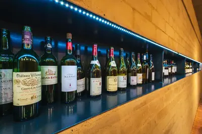 a row of wine bottles sitting on a shelf at Park Holiday Congress & Wellness Hotel in Prague