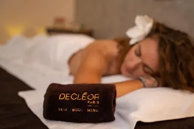 a woman laying on a bed with a sign on it at Park Holiday Congress & Wellness Hotel in Prague