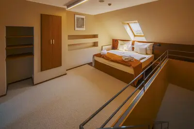 a hotel room with a bed and a balcony at Park Holiday Congress & Wellness Hotel in Prague
