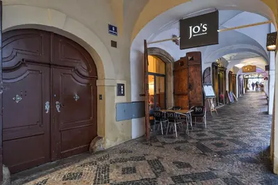 a building with a door and a table and chairs at Romantic Apartment Prague near Charles Bridge in Prague