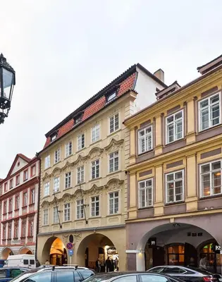 a large building with cars parked in front of it at Romantic Apartment Prague near Charles Bridge in Prague