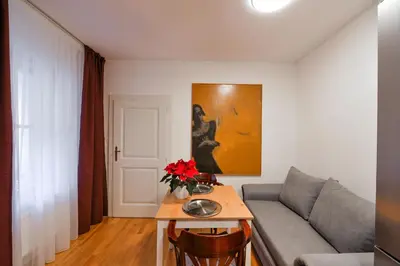 a living room with a couch and a table with flowers at Romantic Apartment Prague near Charles Bridge in Prague