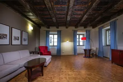 a living room with a couch and a table at Charles Bridge Heritage Suites by SALVATOR HOTELS in Prague