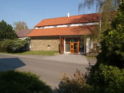 a building with a red roof and a road at Alt pension in Prague
