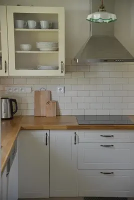 a kitchen with white cabinets and white appliances at Statek Krkavčí Hora in Nižbor