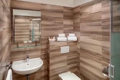 a bathroom with a sink and a toilet at Hotel Atlas in Benešov