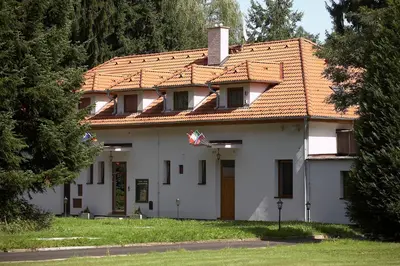 a white house with a red roof at Pension Konopiste in Benešov