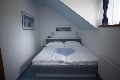 a bedroom with a bed with a heart on it at Pension Konopiste in Benešov