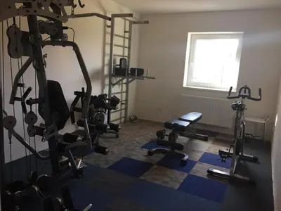 a room with a gym with several tread machines at Hotel Dvůr in Krnsko