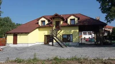 a yellow house with a brown roof at Penzion AMÁLKA Černín in Zdice