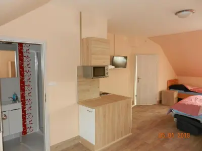 a small kitchen in a small room with a microwave at Penzion AMÁLKA Černín in Zdice