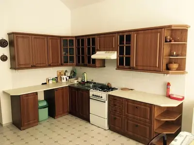 a kitchen with wooden cabinets and a white stove top oven at Zderaz in Prague