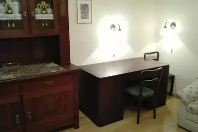 a wooden desk with a chair in a room at Zderaz in Prague