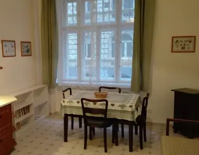 a dining room with a table and chairs and a window at Zderaz in Prague