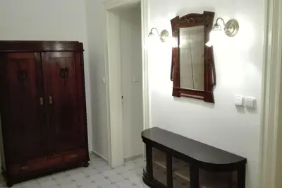 a bathroom with a wooden cabinet and a mirror at Zderaz in Prague