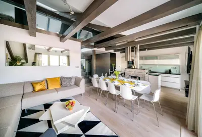 a living room and kitchen with a table and chairs at President APT by Prague Castle, VIEWS in Prague