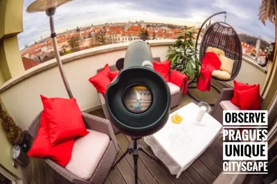a tv on a balcony with chairs and a table at President APT by Prague Castle, VIEWS in Prague