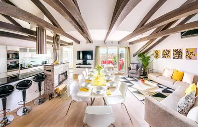 a living room with a white table and a fireplace at President APT by Prague Castle, VIEWS in Prague