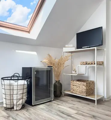 a living room with a television and a tv stand at Apartmán Vikárka - dům Karla Hynka Máchy - Litoměřice in Litoměřice
