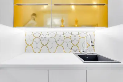 a white kitchen with a sink and yellow cabinets at Drama Queen in Old Town Prague in Prague