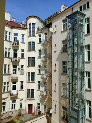 a tall building with a glass tower on the side of it at Drama Queen in Old Town Prague in Prague