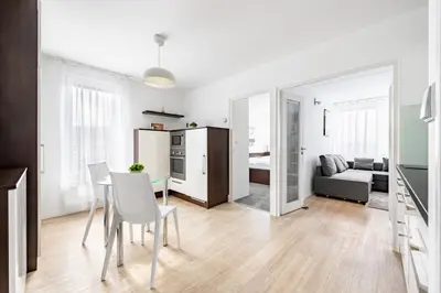 a kitchen and living room with a table and chairs at Family apartment Prague in Prague