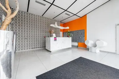 an office with orange and white walls and a lobby at Family apartment Prague in Prague