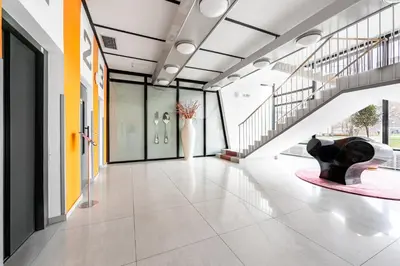 a hallway of a building with a staircase and a sculpture at Family apartment Prague in Prague