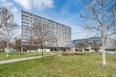 a tall building with a park in front of it at Family apartment Prague in Prague