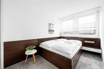 a bedroom with a bed and a window at Family apartment Prague in Prague
