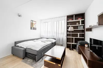 a bedroom with a bed and a table in a room at Family apartment Prague in Prague