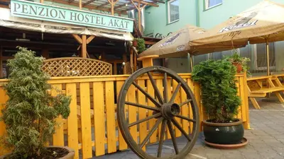 a wooden fence with a woodenoked wheel and some plants at Pension Akat in Prague