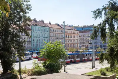 a city street with a train in front of buildings at Pension Akat in Prague