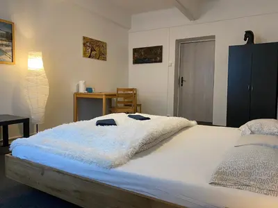 a bedroom with a bed with a white blanket at Motel Grádo in Prague