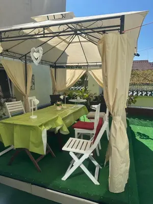 a table and chairs under an umbrella on a patio at ARTHARMONY Pension & Hostel in Prague